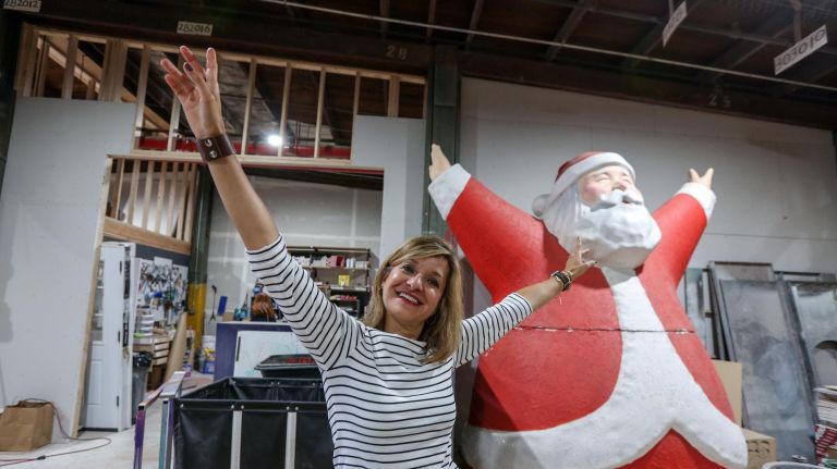 Roya Sullivan, the national windows director at Macy's, with&nbsp;Santa at a behind-the-scenes look at the Macy's holiday window display at their workshop in Red Hook.