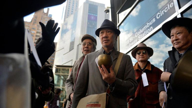 Perry Yung (52) rings a Buddhist bell to start a Silent Peace March at Columbus Circle in Manhattan on Saturday, Feb. 18, 2017. About two dozen people walked from Columbus Circle to the Japanese American Church on 7th Ave. to commemorate the Japanese Americans who were held in concentration camps on U.S. soil 75 years ago after President Franklin D. Roosevelt signed executive order 9066 in 1942, which authorized the U.S. military to remove 120,000 people of Japanese descent, most of whom were American citizens from their homes on the west coast to inland concentration camps. To commemorate the day and to show solidarity with Muslim Americans who fear being banned from the U.S., dozens of people walked to the Japanese American Church during a Day of Remembrance silent march.
