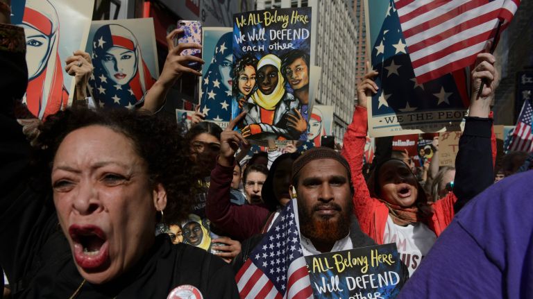 New Yorkers cheer and hold signs at the I Am A Muslim Too rally in Times Square on Feb. 19, 2017. 
