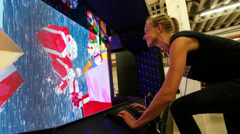 Jennifer Brickman tries out window 5, which includes&nbsp;an interactive game you drive with a steering wheel that sticks out from the window.