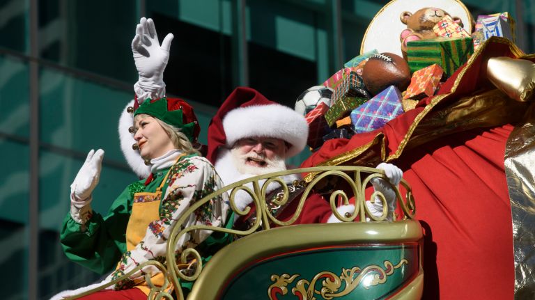 Santa, riding his sleigh, kicks off the holiday season near the end of the parade.