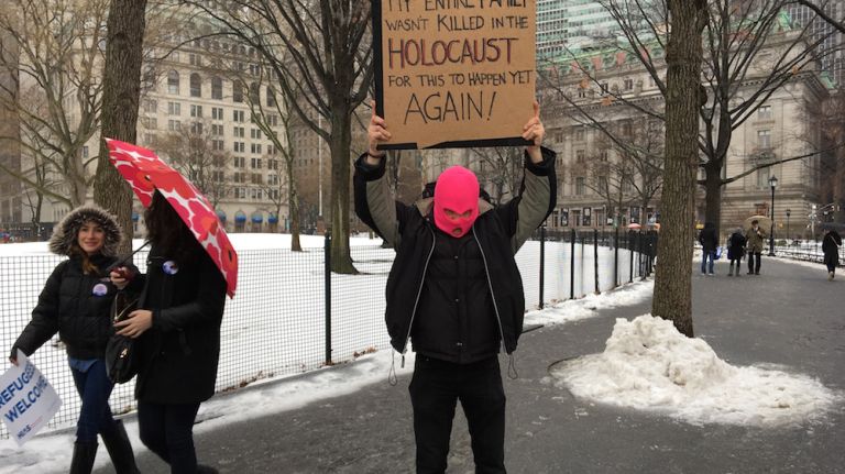 Protesters braved the rain and gathered in Battery Park to attend a rally in support of refugees on Feb. 12, 2017. 