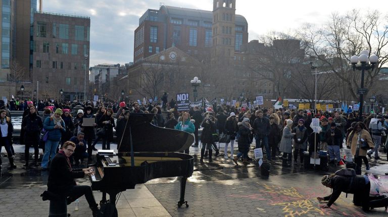 Pianist Colin Huggins performs during an immigration rally at Washington Square Park on Saturday, Feb. 11, 2017. The rally was held to challenge the criminalization of immigrants under the NYPD's current Broken Windows policy, before it worsens under President Trump's far-right administration.