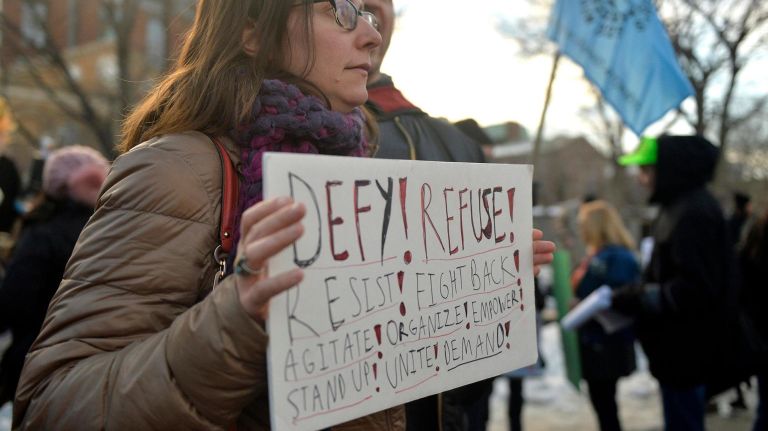 A protest sign urges people to resist and fight back during a rally at Washington Square Park on Saturday, Feb. 11, 2017. The rally was held to challenge the criminalization of immigrants under the NYPD's current Broken Windows policy, before it worsens under President Trump's far-right administration.