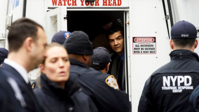 City Council  member  Ydanis Rodriguez sits in the back of a NYPD vehicle earlier this month after  he was  arrested during an immigration rally in Manhanttan. 