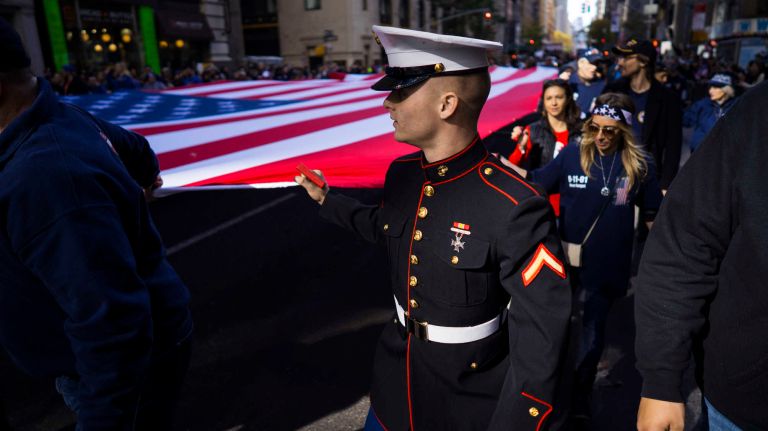 A unit carrying the Ground Zero Volunteers Flag march up Fifth Avenue during the Veterans Day Parade in Manhattan on Friday, Nov. 11, 2016.