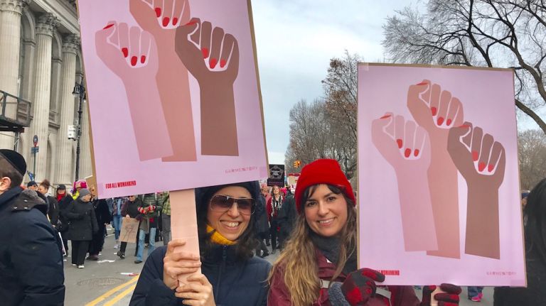 Women's March evolves to celebrate diverse voices 1 Women's March attendees Nara Irigoyen, 48, left, and Kaylee Russotti, 29, hold up signs by Brooklyn-based Garmentory titled