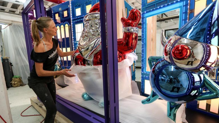 Jennifer Brickman, head of the props department for the Macy's holiday window display, unwraps&nbsp;chrome balloons of Santa and his elves.