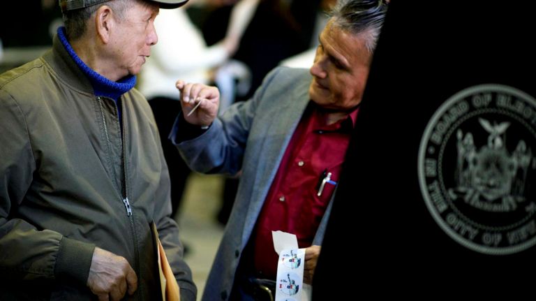 Voters cast their ballots at St. Sebastian's School in Woodside, Queens.
