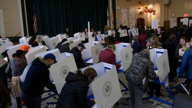 Voters cast their ballots at St. Sebastian's School in Woodside, Queens on Monday, Nov. 8, 2016.