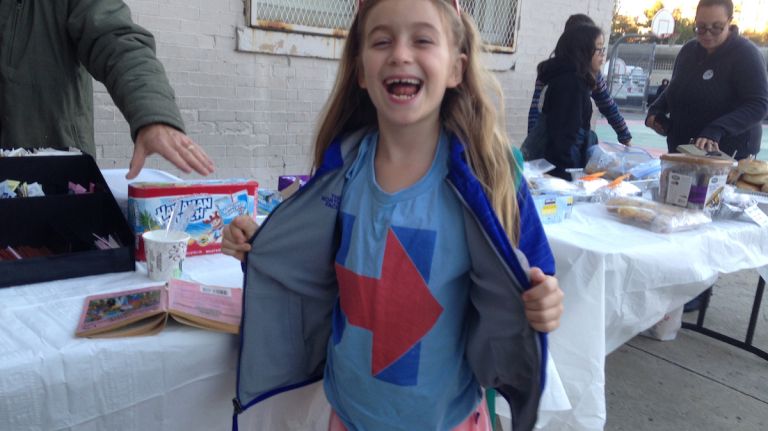 Kaya Friedman, 7, shows her support for Democratic presidential nominee Hillary Clinton at a polling site in Brooklyn's Windsor Terrace neighborhood on Nov. 8, 2016.