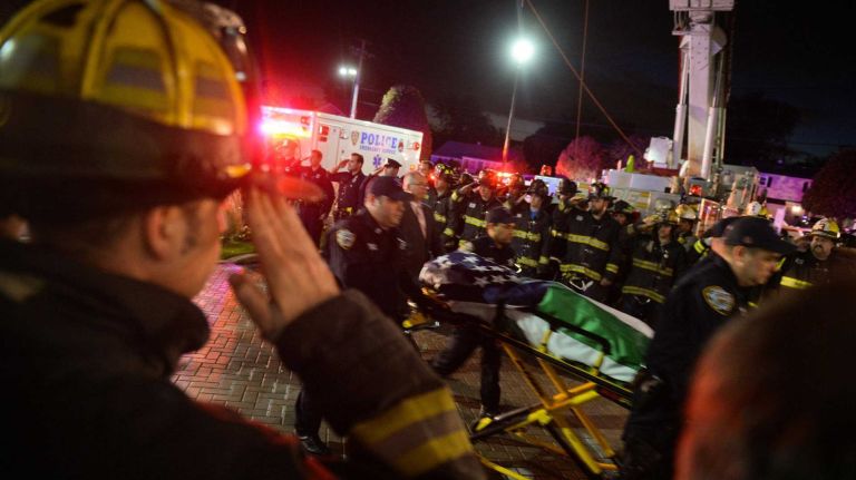 Bronx police shooting: Photos from the scene and more 27 Police officers and firefighters salute the body of slain NYPD Sgt. Paul Tuozzolo at the Chapey & Sons Funeral Home in Bethpage on Saturday, Nov. 5, 2016. Tuozzolo's body was transported to the funeral home by ambulance.