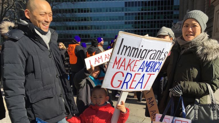 A family gathers at a demonstration at Battery Park, protesting against President Donald Trump's recent executive order on immigration travel.
