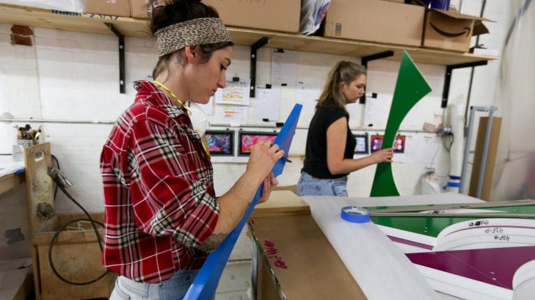 Workers make part of a Christmas tree at their workshop in Red Hook.