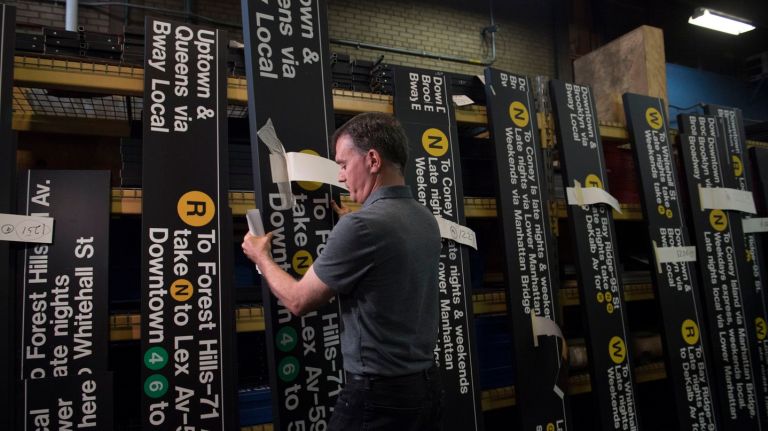 John Kern, assistant director of Station Signage, shows off some of the finished signs on Tuesday, Oct. 25, 2016, as the MTA gets ready for the return of the W train.