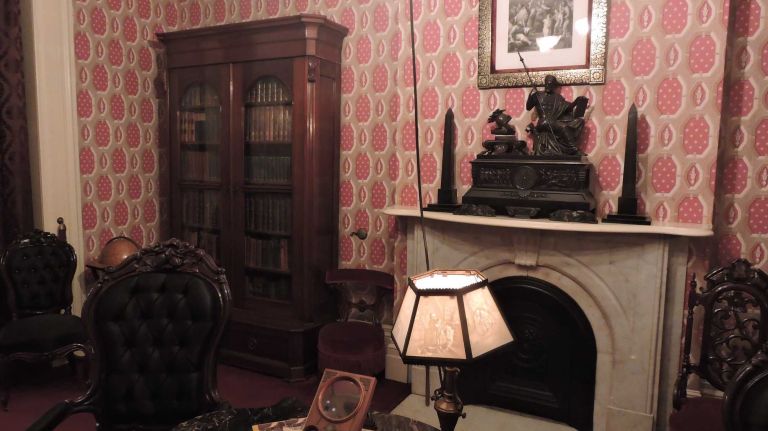 Tours begin on the home's ground floor with a peek at the Roosevelts' library. Shelves on either end of the room are stocked full of the family's old books. Between one bookshelf and the room's fireplace is a red chair that young Teddy loved sitting in to get lost in a new read. And we don't blame him: This unique library is definitely one for the books. 