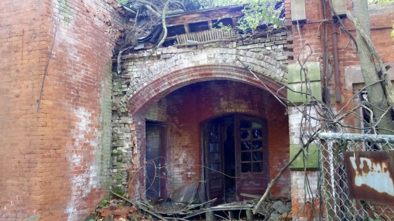 Even utilitarian buildings are adorned with details.This boiler room building has a wrought iron banister for stairs that are no longer safe to climb.