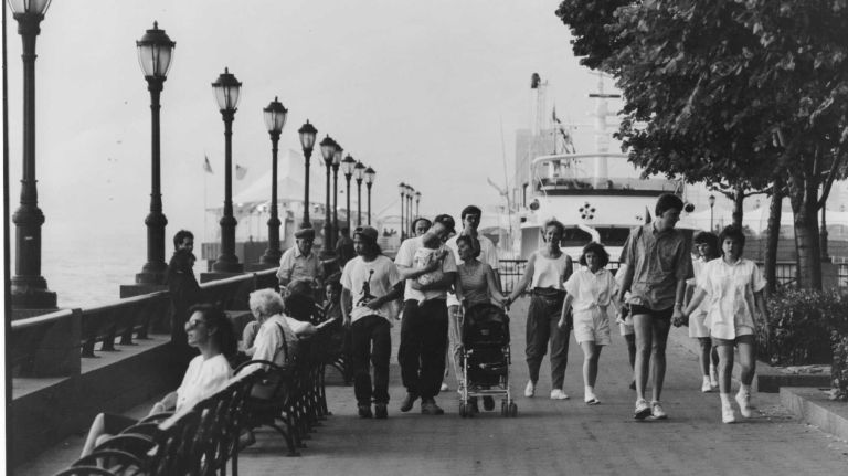 People enjoy the promenade at Battery Park City on July 22, 1990.