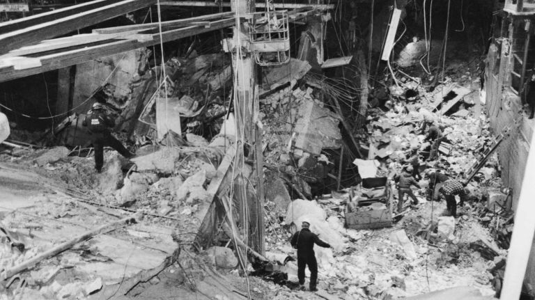 Bomb squad investigators search for evidence, and construction workers remove rubble on March 12, 1993, after a bombing at the World Trade Center on Feb. 26 that killed six people.