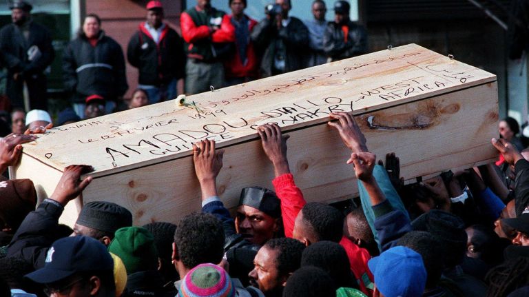 Community members help carry the body of Amadou Diallo out of The Islamic Cultural Center of New York after his funeral service on Feb. 12, 1999. Diallo, an unarmed West African street vendor, was shot and killed in the Bronx by four NYPD officers on Feb. 4, 1999. The officers had fired 41 bullets; 19 hit Diallo. The officers were later acquitted of all charges at trial.