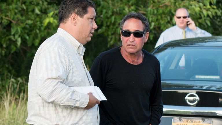 Karina Vetrano's father, Philip, seen above wearing a black shirt, joins police as they investigate the homicide scene at the marsh at Spring Creek Park near the Belt Parkway. Vetrano, who lived nearby, was reported missing after she went jogging and did not return.