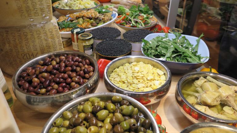 Olives, caviar and other prepared foods based on the recipes of partners Joe Bastianich, Lidia Bastianich and Mario Batali are sold at this counter in the market. 