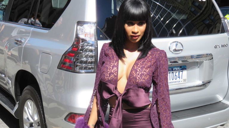A guest stops for photos before the Vera Wang show at the Skylight at Moynihan Station in Manhattan during New York Fashion Week on Tuesday, Sept. 13, 2016.