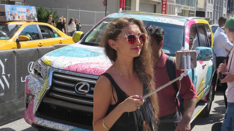 A guest uses her selfie stick at the Skylight at Moynihan Station in Manhattan during New York Fashion Week on Tuesday, Sept. 13, 2016.