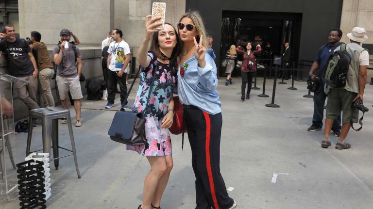 Friends take a selfie outside the Michael Costello show during New York Fashion Week at the Skylight at Moynihan Station in Manhattan on Thursday, Sept. 8, 2016.