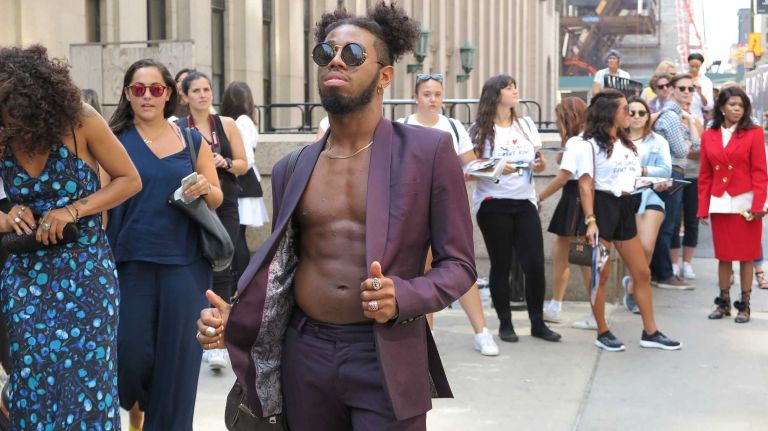 A guest struts his stuff as he heads to the Michael Costello show during New York Fashion Week at the Skylight at Moynihan Station in Manhattan on Thursday, Sept. 8, 2016.