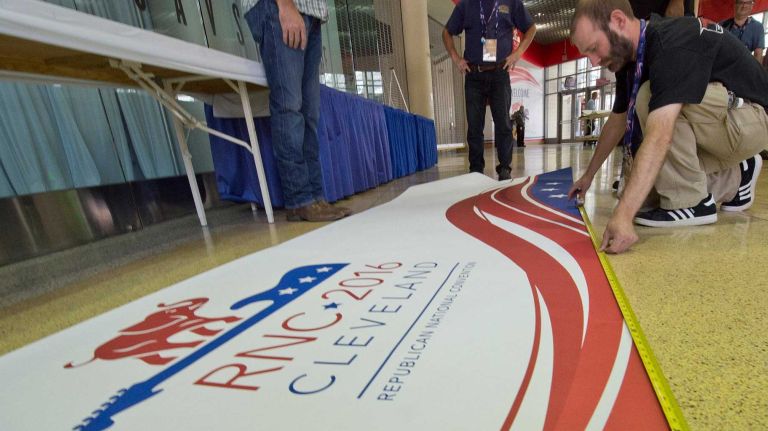 Workers prepare the Quicken Loan Arena with signage at the Republican National Convention in Cleveland, Ohio, on Sunday, July 17, 2016.
