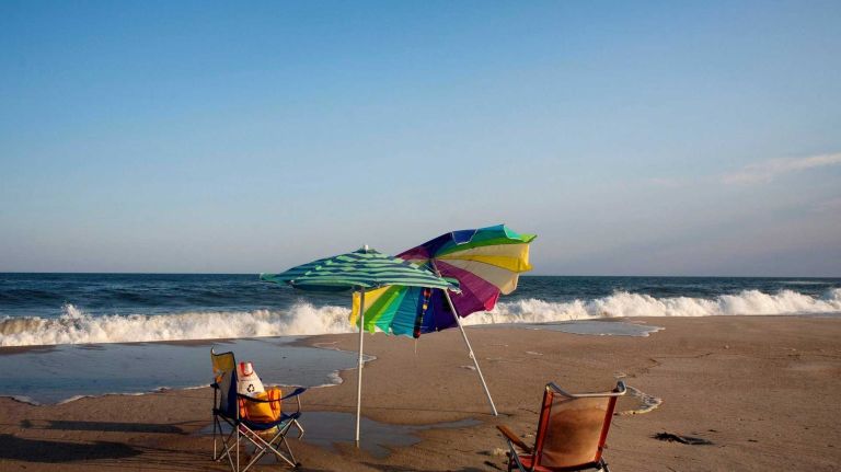 Empty beach chairs and umbrellas sit on the beach in Cherry Grove on Fire Island, July 11, 2010. 