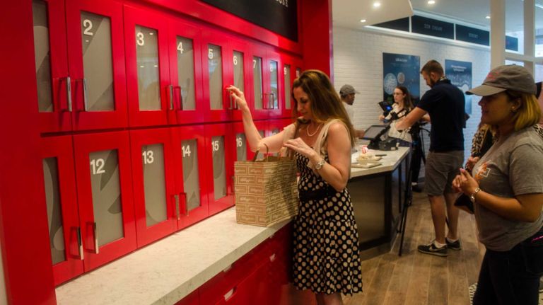 Unlike a typical cereal bar, Kellogg's NYC customers don't walk down a line to pick their cereals, toppings and milk. Instead, they choose a premade cereal dish from the menu -- or customize their own -- and pick up their order at a numbered cabinet, which looks like an Automat machine or a kitchen cupboard. 