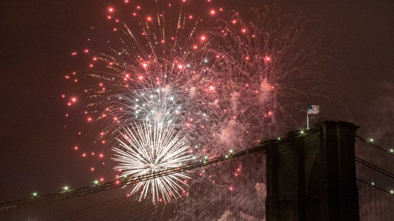 People watch the Macy's Fourth of July Fireworks from Brooklyn Bridge Park on July 4, 2016.