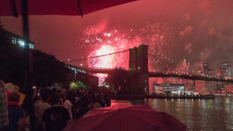 People watch the Macy's 4th of July Fireworks from Brooklyn Bridge Park on July 4, 2016.