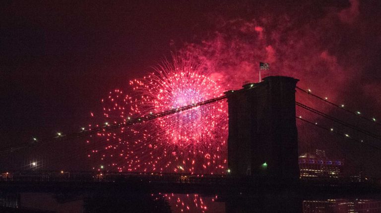 People watch the Macy's 4th of July Fireworks from Brooklyn Bridge Park on July 4, 2016.