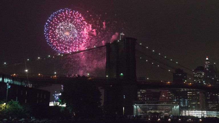People watch the Macy's 4th of July Fireworks from Brooklyn Bridge Park on July 4, 2016.