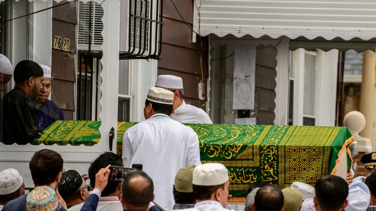 Pallbearers carry the body of Imam Maulama Akonjee into Furqan Jame Masjid Mosque on Glenmore Avenue in Ozone Park, Queens, on Monday, Aug. 15, 2016.
