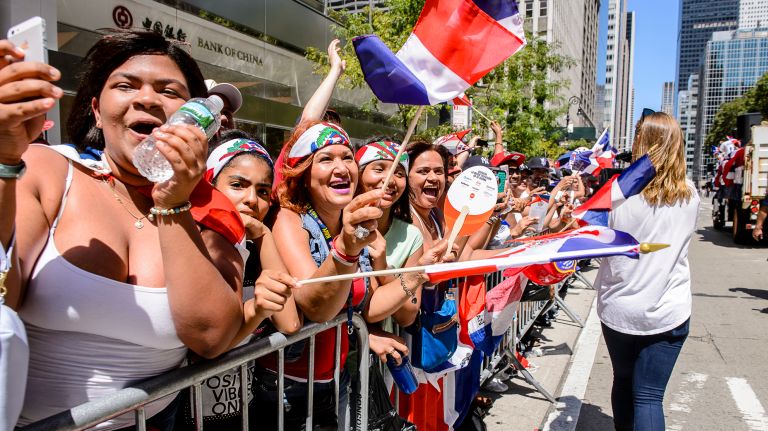 Enthusiastic crowds line the route at the Dominican Day Parade on Avenue of the Americas, Sunday, Aug. 13, 2017.
