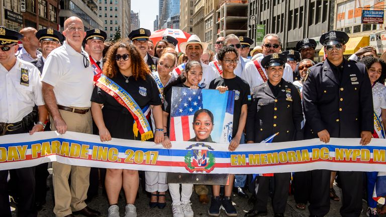 NYPD Commisioner James O'Neill, Miosotis Familia's eldest daughter and her twins, attend the ribbon ceremony at the Dominican Day Parade on Avenue of the Americas, Sunday, Aug. 13, 2017.