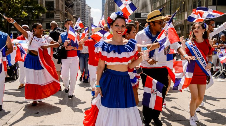 Colorfully costumed participants march at the Dominican Day Parade on Avenue of the Americas, Sunday, Aug. 13, 2017.