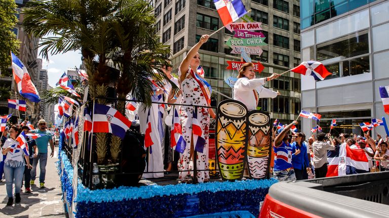 Colorfully costumed participants march at the Dominican Day Parade on Avenue of the Americas, Sunday, Aug. 13, 2017.