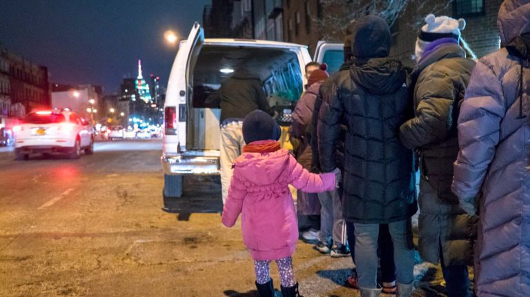 Coalition for the Homeless staff and volunteers offer food and clothing items to those in need near Chinatown on Wednesday, Jan. 3, 2018.