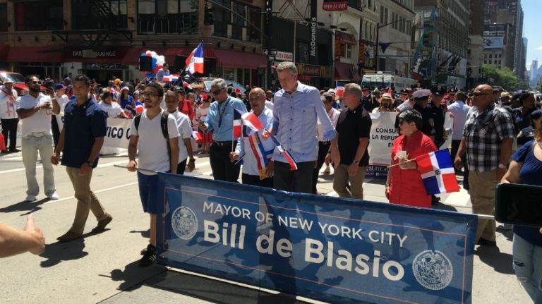 Mayor Bill de Blasio marches behind the contingent from the New York Dominican Officers Organization at the Dominican Day Parade on Avenue of the Americas, Sunday, Aug. 13, 2017.