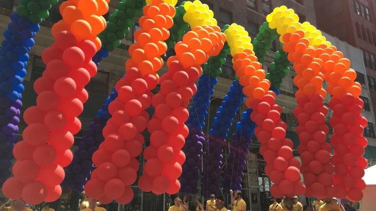 NYC Pride March participants hold rainbow balloons before the parade kicks off on Fifth Avenue in Manhattan on Sunday, June 25, 2017.