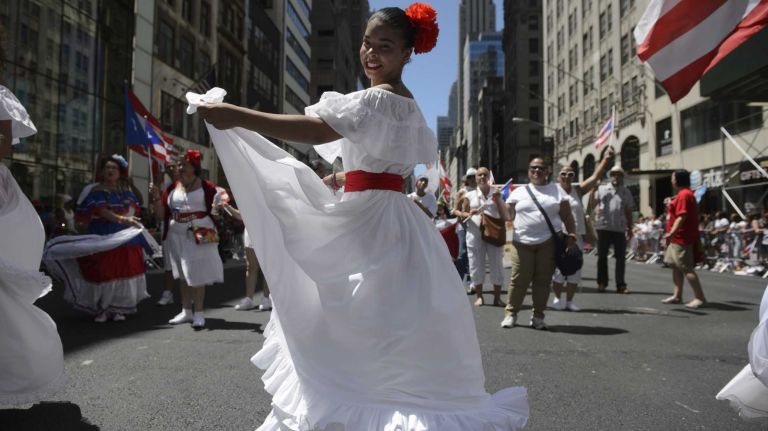 Participants in the annual Puerto Rican Day Parade dance as they march up Fifth Avenue in Manhattan on Sunday, June 12, 2016. The parade's theme 