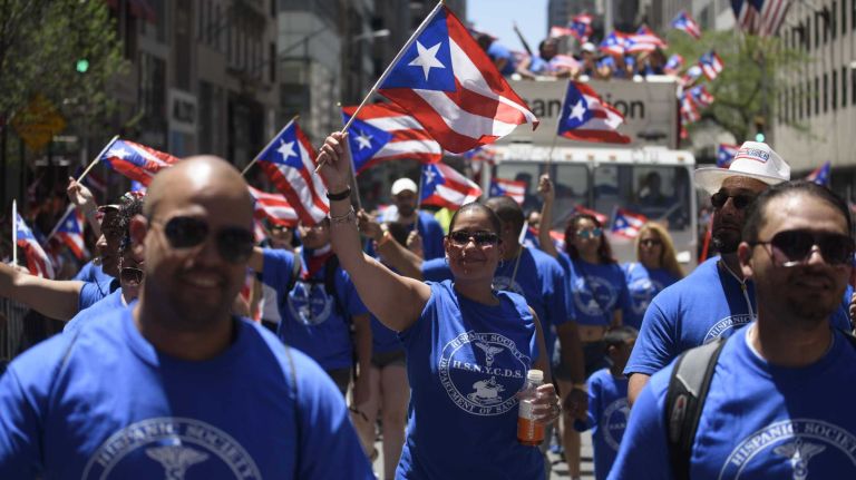 Members of the New York City Department of Sanitation Hispanic Society march along Fifth Avenue during the 59th Annual Puerto Rican Day Parade in Manhattan on Sunday, June 12, 2016.