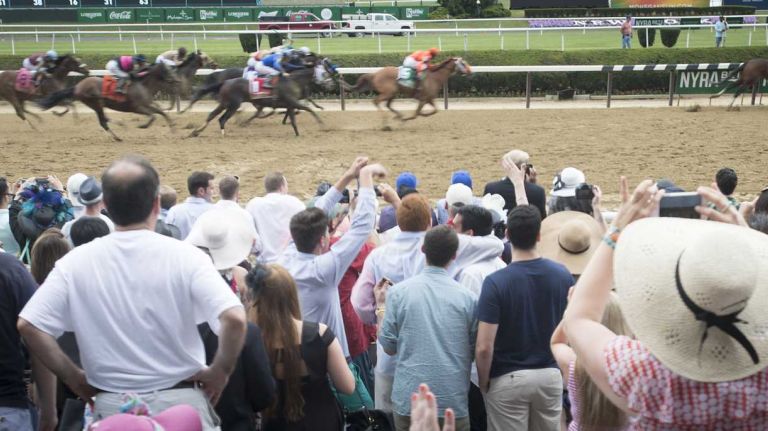 Horse racing fans cheer during the Brooklyn Invitational race on June 11, 2016, before the running of the 148th Belmont Stakes at Belmont Park in Elmont.