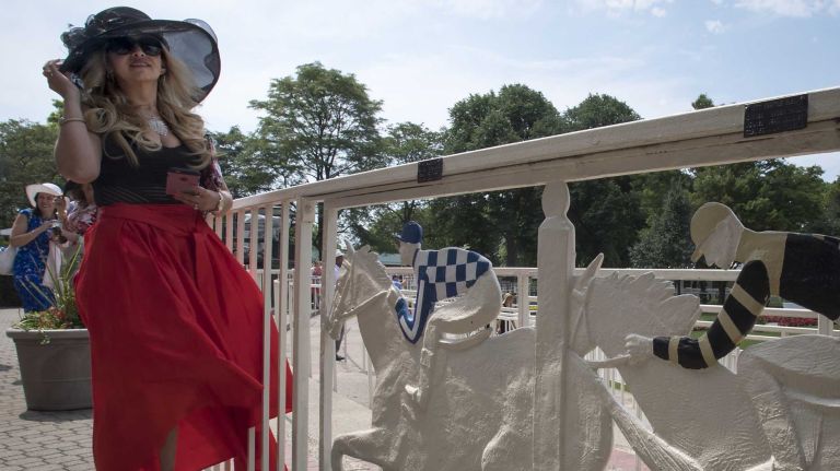 Alcira Chevez is styling a black hat on Saturday, June 11, 2016, during festivities before the running of the 148th Belmont Stakes at Belmont Park in Elmont.
