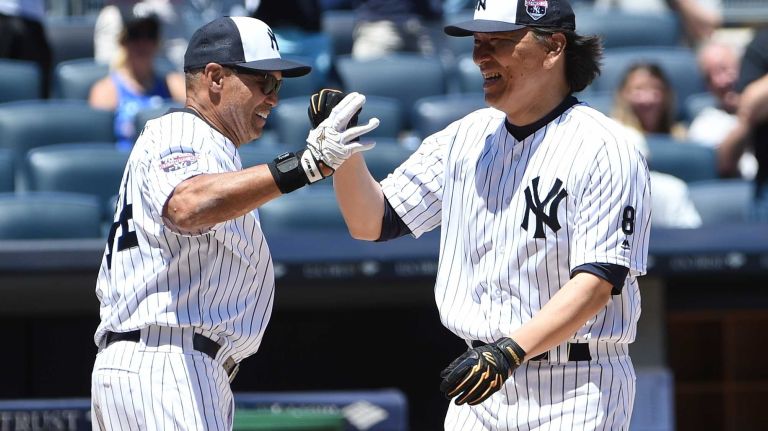 Former New York Yankees player Reggie Jackson greets former player Hideki Matsui after his two-run home run during the 70th annual Old-Timers' Day game at Yankee Stadium on Sunday, June 12, 2016.